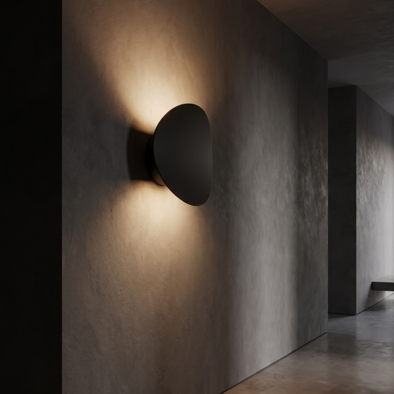 Tilted Disc LED Wall Sconce in a dark modern hallway