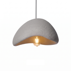 Wabi sabi stone-look pendant light on white background
