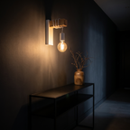 Modern Industrial Wall Sconce above a black console in a dark hallway