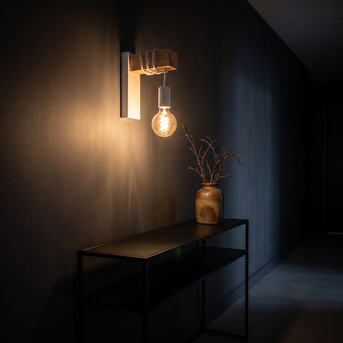 Modern Industrial Wall Sconce above a black console in a dark hallway