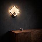 Modern LED Wall Sconce above a walnut sideboard in a dark living room