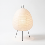 Table Lamp with Tall Rice Paper Egg Shade on Black Tripod Legs on white background