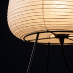 Table Lamp with Tall Rice Paper Egg Shade on Black Tripod Legs lifestyle 4
