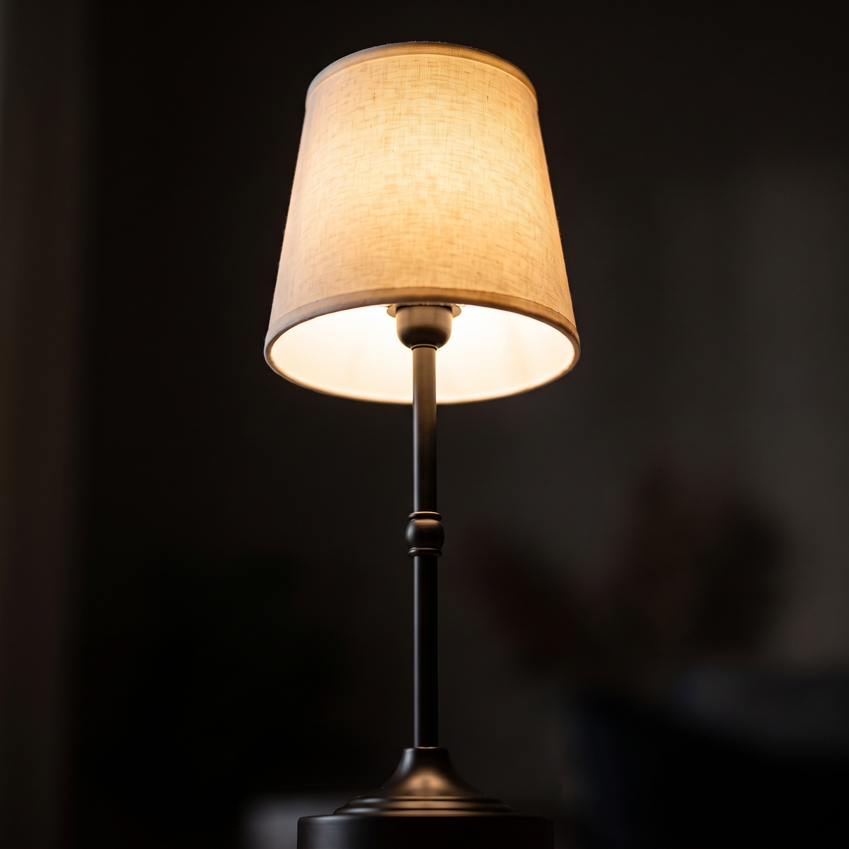 Close-up of the glowing fabric shade of the Dimmable Cordless Table Lamp