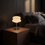Modern Glass Mushroom Table Lamp on a walnut bedside table in a dark bedroom