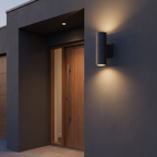 Cylinder Up & Down Outdoor Wall Light shown to scale beside a front door on a dark rendered exterior wall at dusk