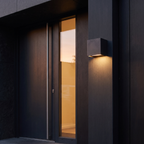 Up & Down Outdoor Wall Light shown to scale beside a front door on a dark exterior wall at dusk