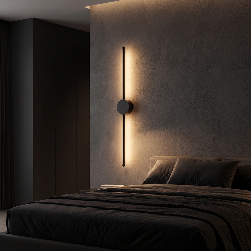 Long Bar LED Wall Light mounted on a charcoal wall beside a bed in a dark bedroom