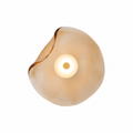 Wavy glass wall sconce in amber glass on white background