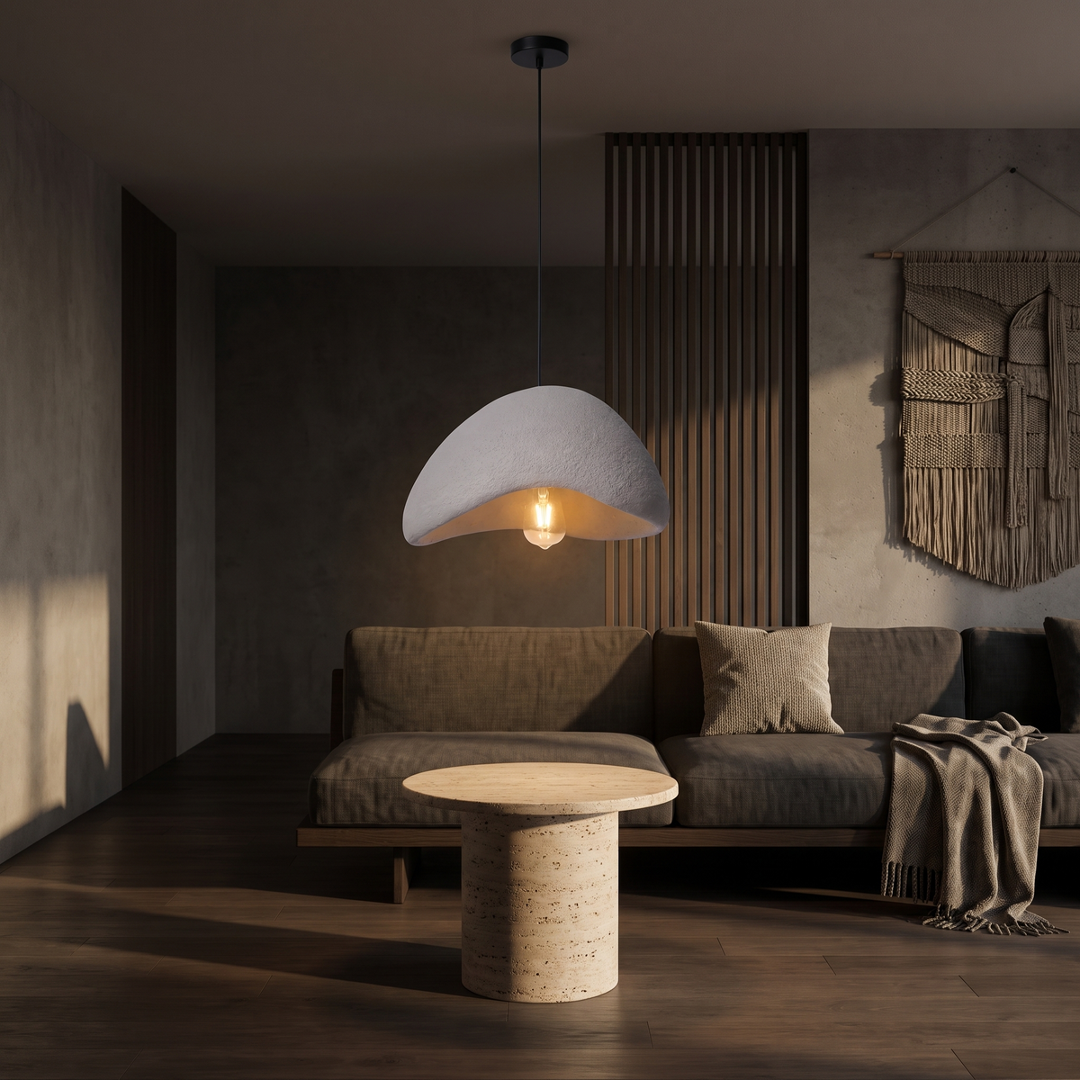 Wabi sabi stone-look pendant light hanging over a round travertine side table in a Japandi living room