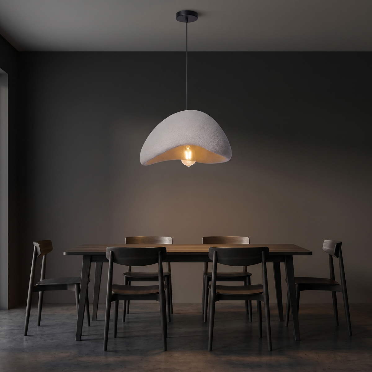Wabi sabi stone-look pendant light shown to scale, hanging over a 4-seat dining table