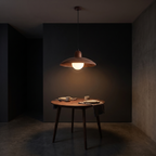 Walnut-finish dome pendant light shown to scale, over a small round dining table for two