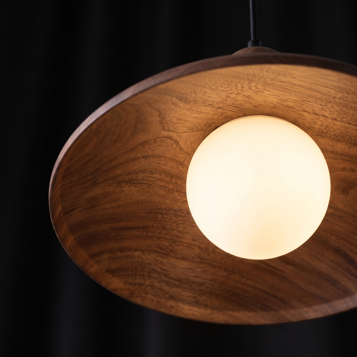 Close-up of the walnut-finish dome pendant light and opal glass globe