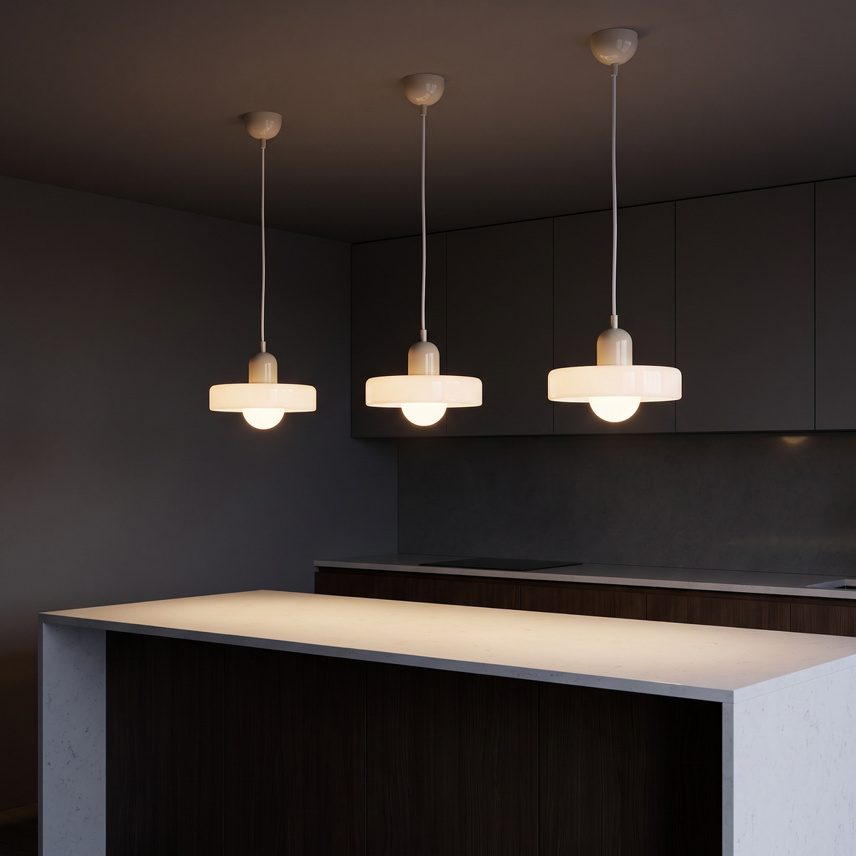 Two-tone colored glass halo pendant lights, three in a row over a white kitchen counter