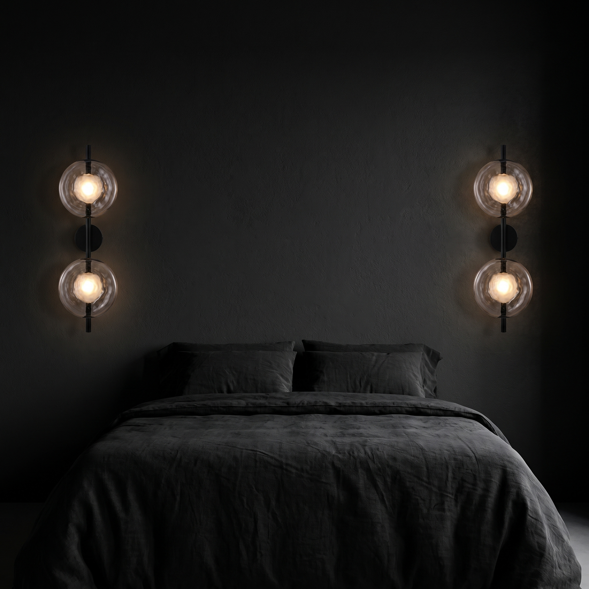 Double glass disc wall sconces, a pair mounted either side of a bed on a dark wall