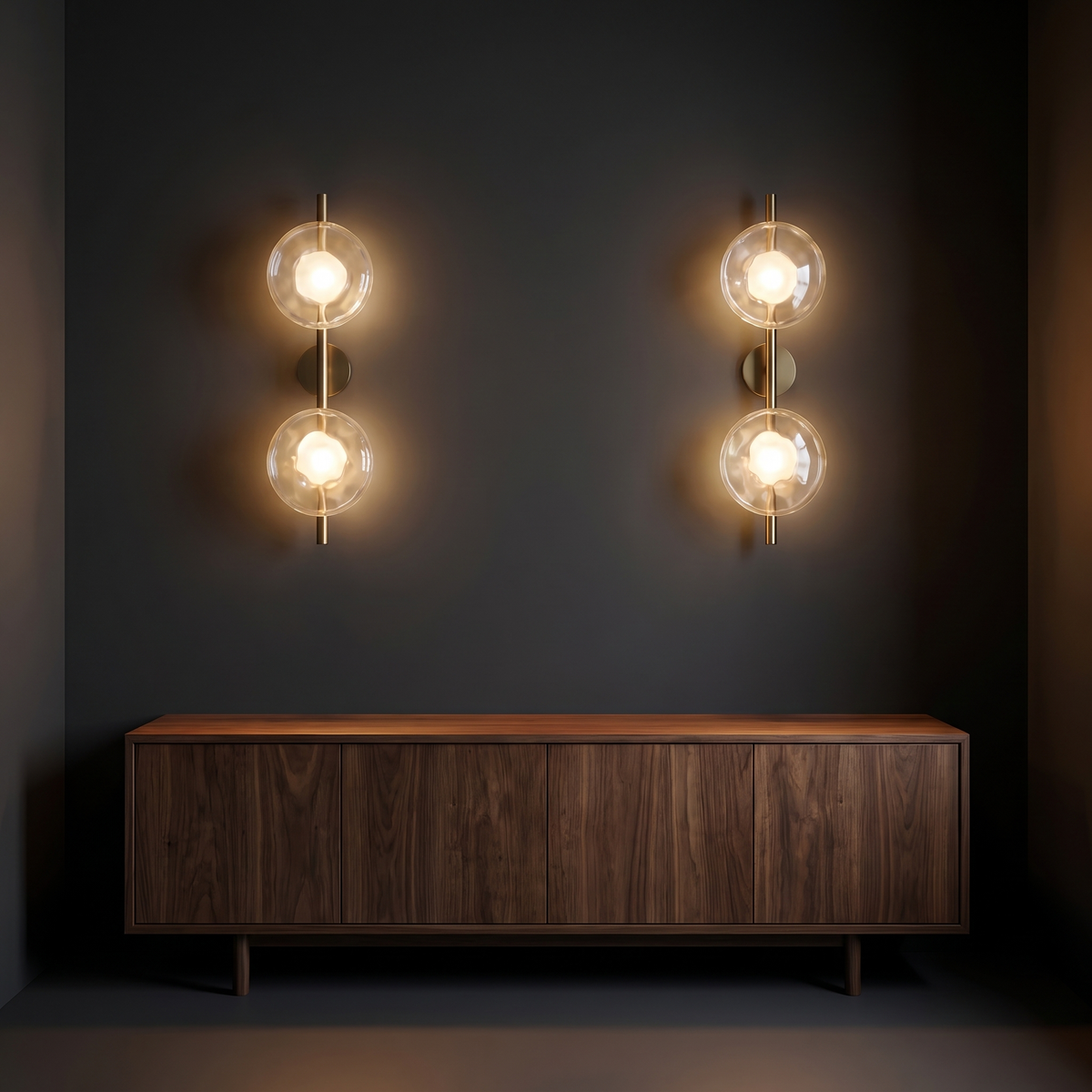 Double glass disc wall sconces above a sideboard in a dark living room