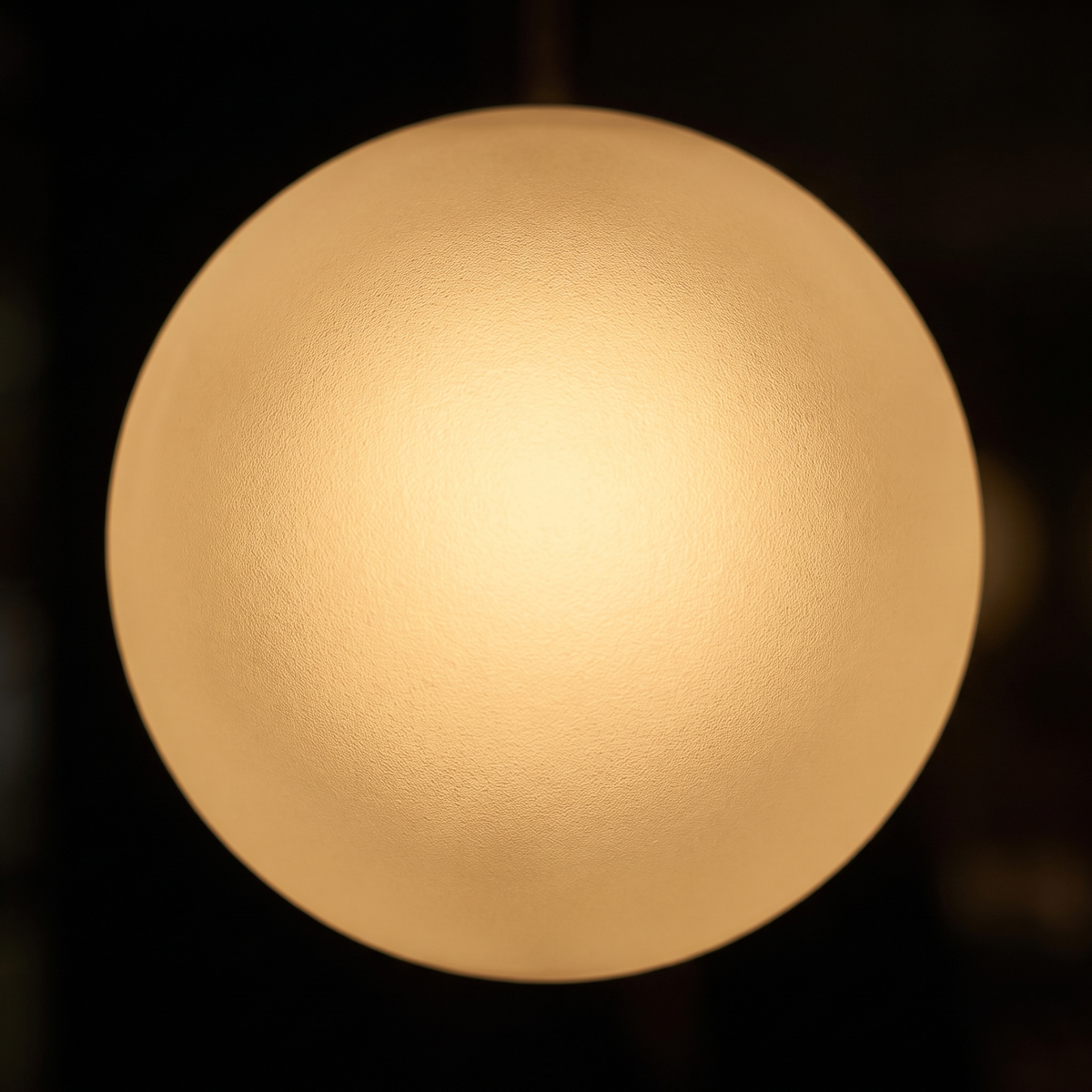Close-up of the glowing frosted glass globe