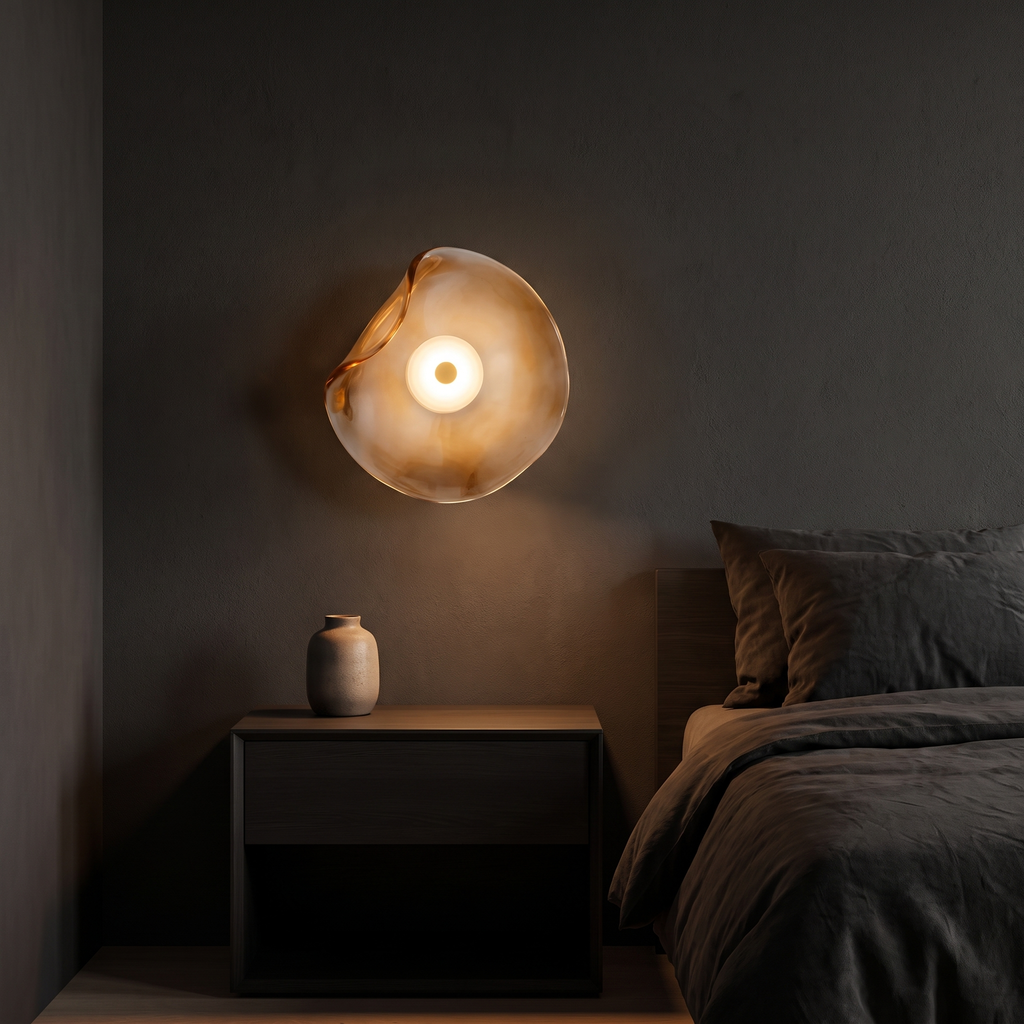 Wavy glass wall sconce shown to scale, mounted above a nightstand beside a bed
