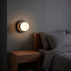 Small globe wall sconce shown to scale, mounted beside a bed above a nightstand