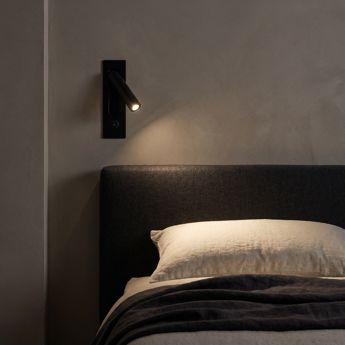 Recessed Bedside Reading Light beside a headboard at night