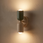 Two-Tone Up Down Wall Sconce casting light up and down a plaster wall