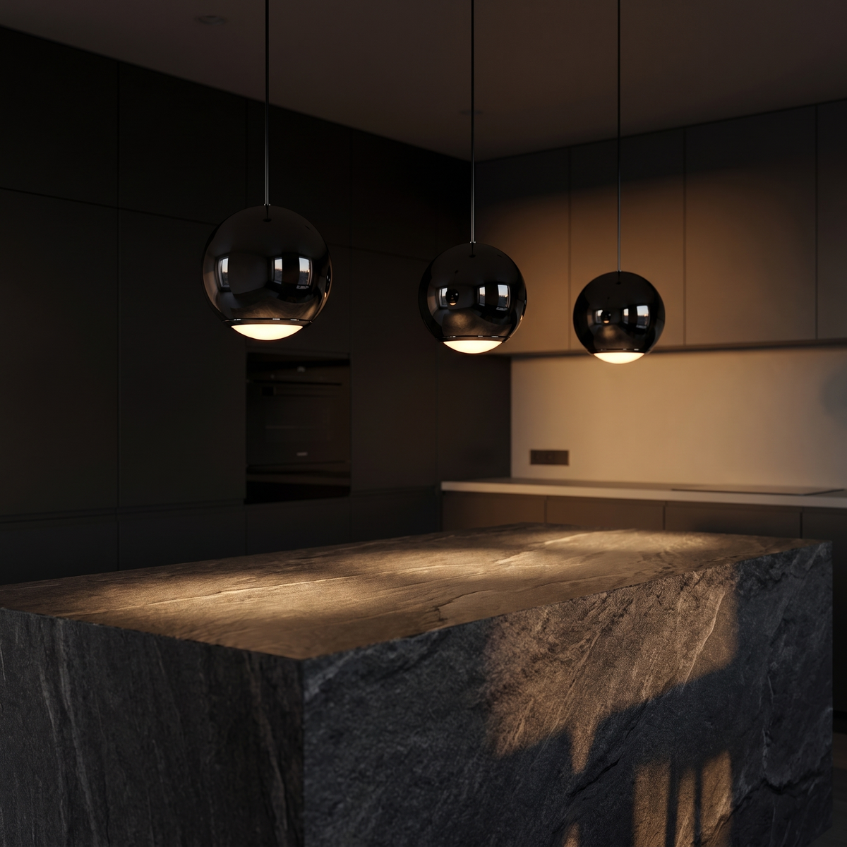 Three Black Mirror Globe Pendant Lights over a stone kitchen island