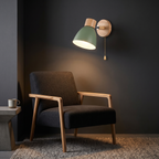 Nordic Wood Wall Sconce with Pull Chain in green above a reading chair
