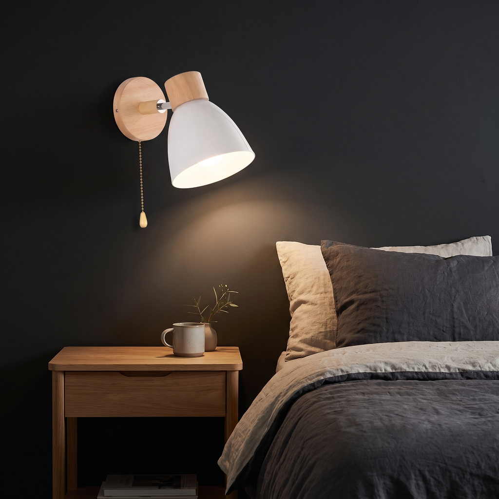 Nordic Wood Wall Sconce with Pull Chain in white beside a bed