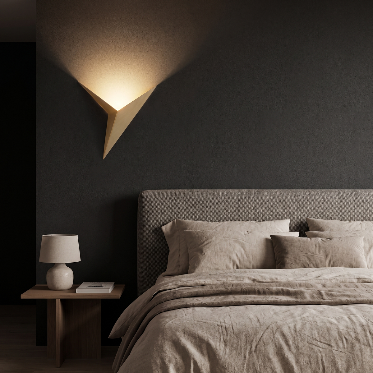 Gold Triangle LED Wall Sconce beside a bed at night
