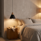 Black Nordic Cone Pendant Light hanging beside a bed at night