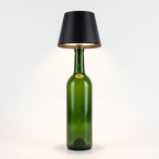 Black round shade cordless bottle lamp on a green bottle, white background