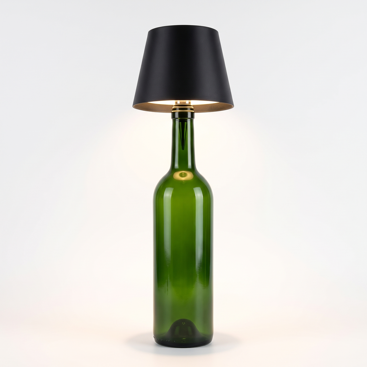 Black round shade cordless bottle lamp on a green bottle, white background