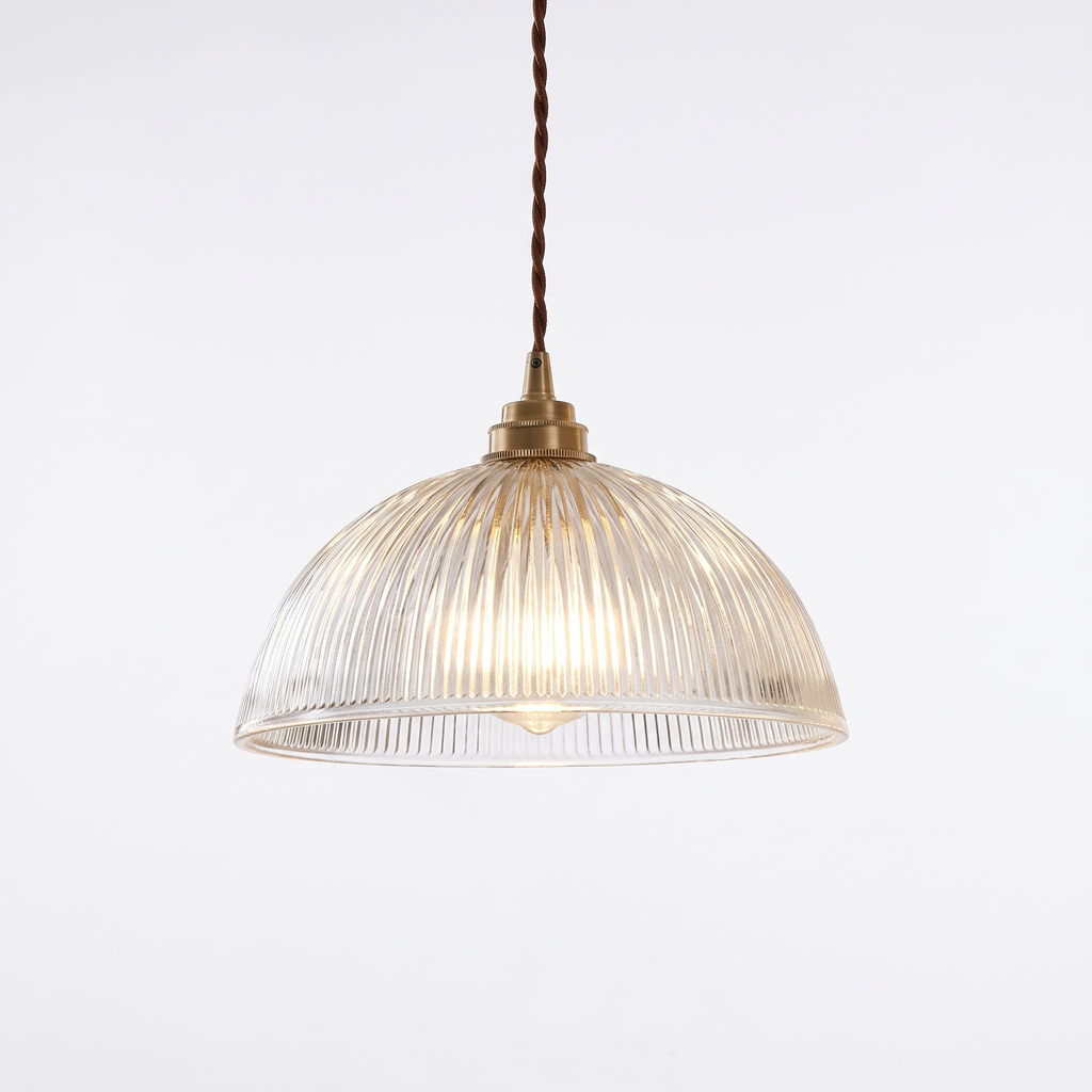 Ribbed glass dome pendant light with brass socket on white background