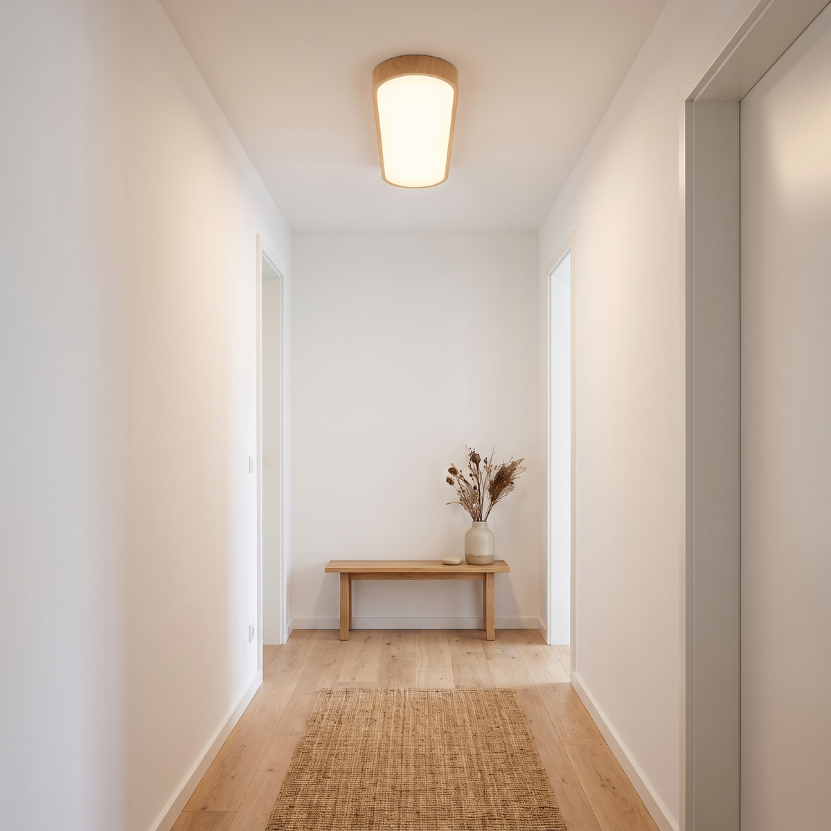Oval wood LED flush mount ceiling light in a hallway