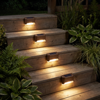 Solar step lights glowing on wooden deck stairs at night