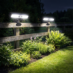 Clip on solar motion lights on a garden fence at night