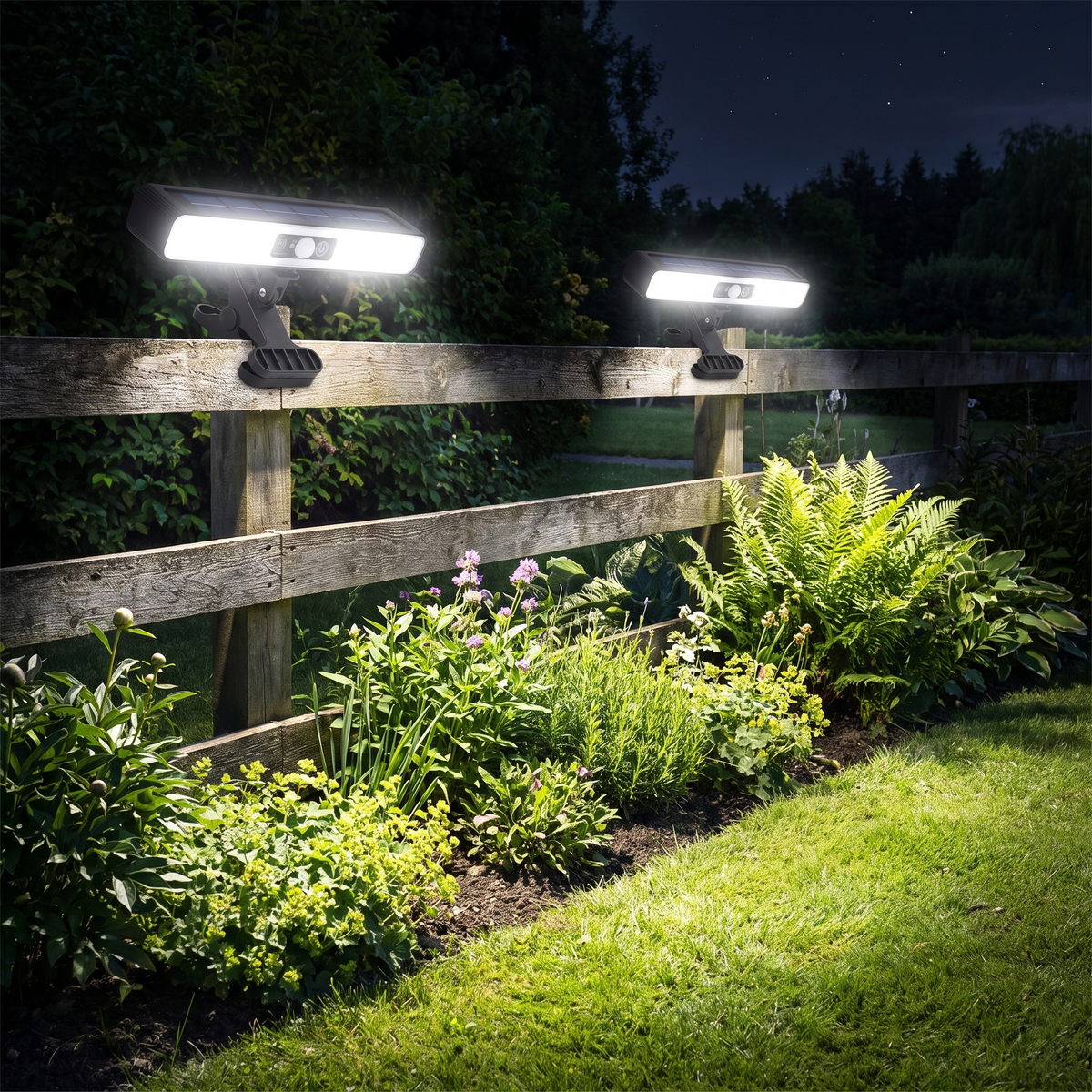 Clip on solar motion lights on a garden fence at night