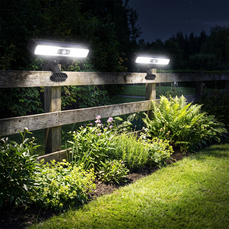 Clip on solar motion lights on a garden fence at night