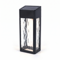 Black solar wall lantern with ripple glass on white background