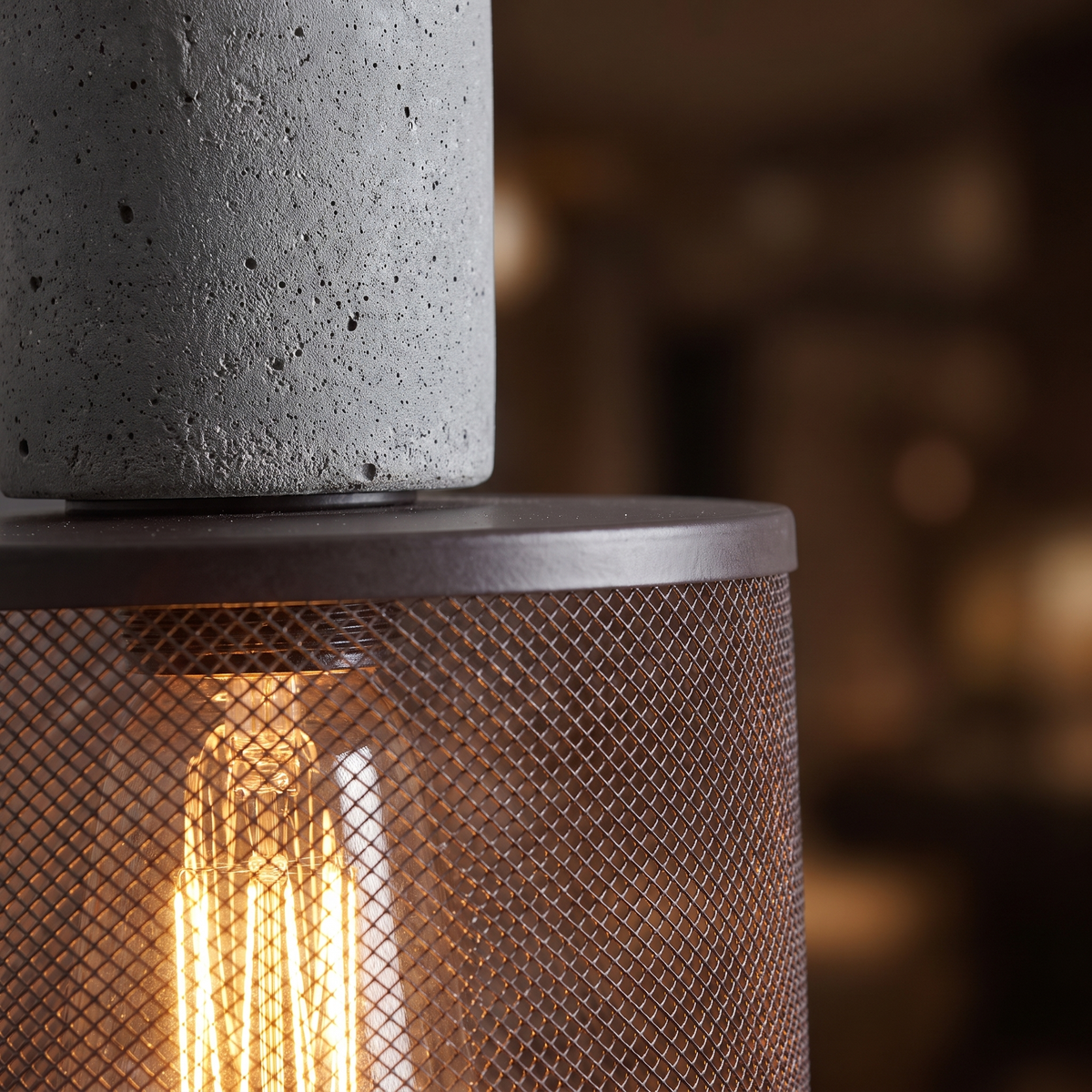 Concrete and Mesh Pendant Light close-up of the concrete cap and glowing mesh shade