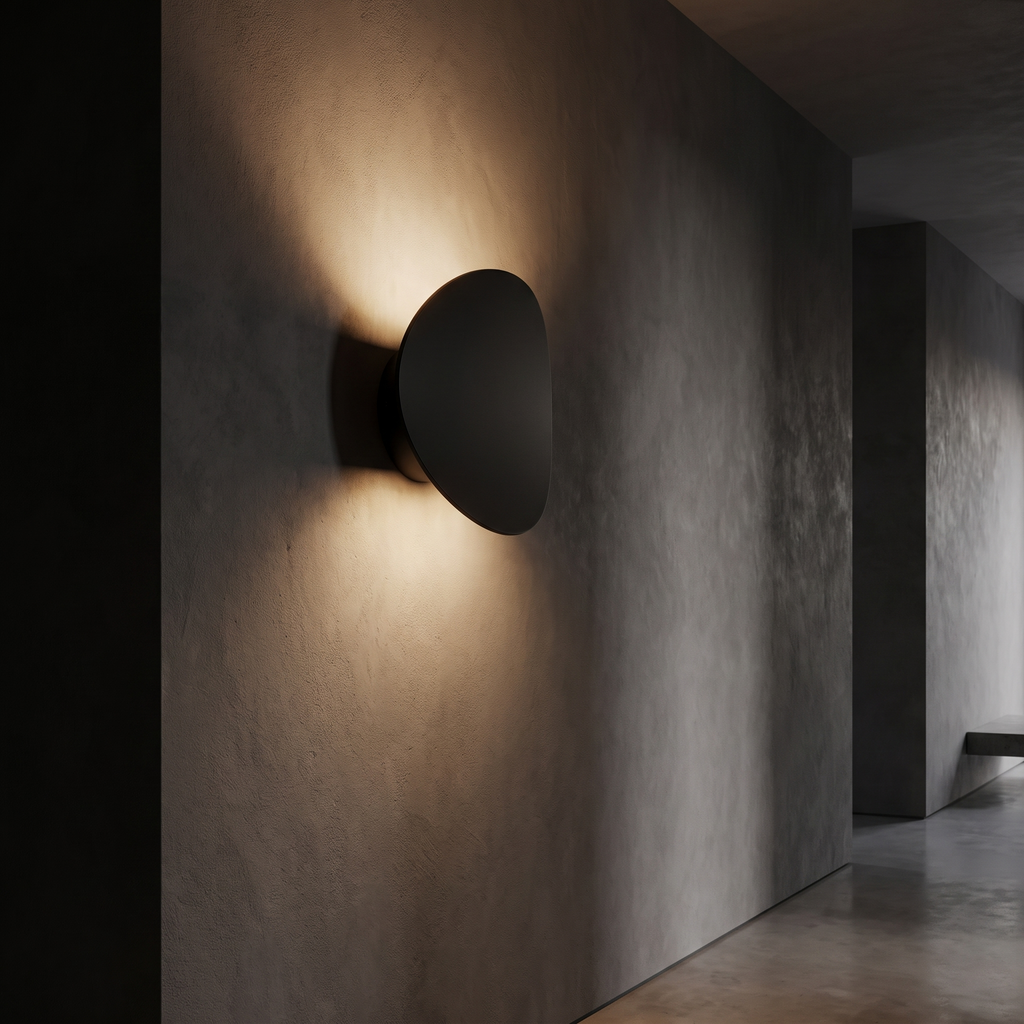 Tilted Disc LED Wall Sconce in a dark modern hallway