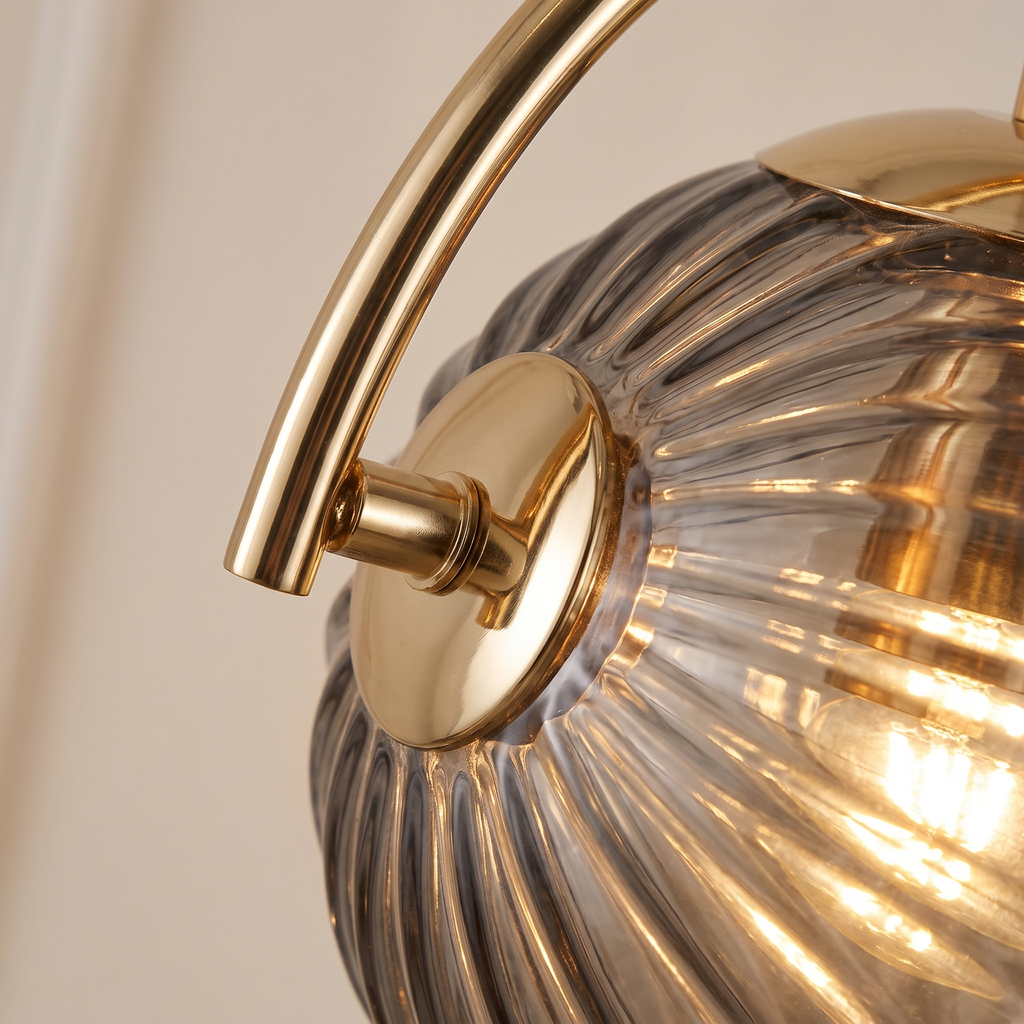 Ribbed Glass Globe Wall Sconce close-up of the ribbed glass and gold arm