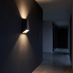 Angled Up Down LED Wall Light in a dark modern hallway