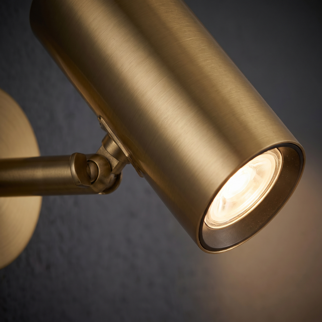 Adjustable Cylinder Wall Spotlight close-up of the gold cylinder head and pivot