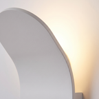 Curved LED Wall Sconce close-up of the curved aluminum panel and uplight