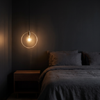 Gold Circle Pendant Light in a dark modern bedroom