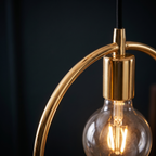 Gold Circle Pendant Light close-up of the gold ring and globe bulb