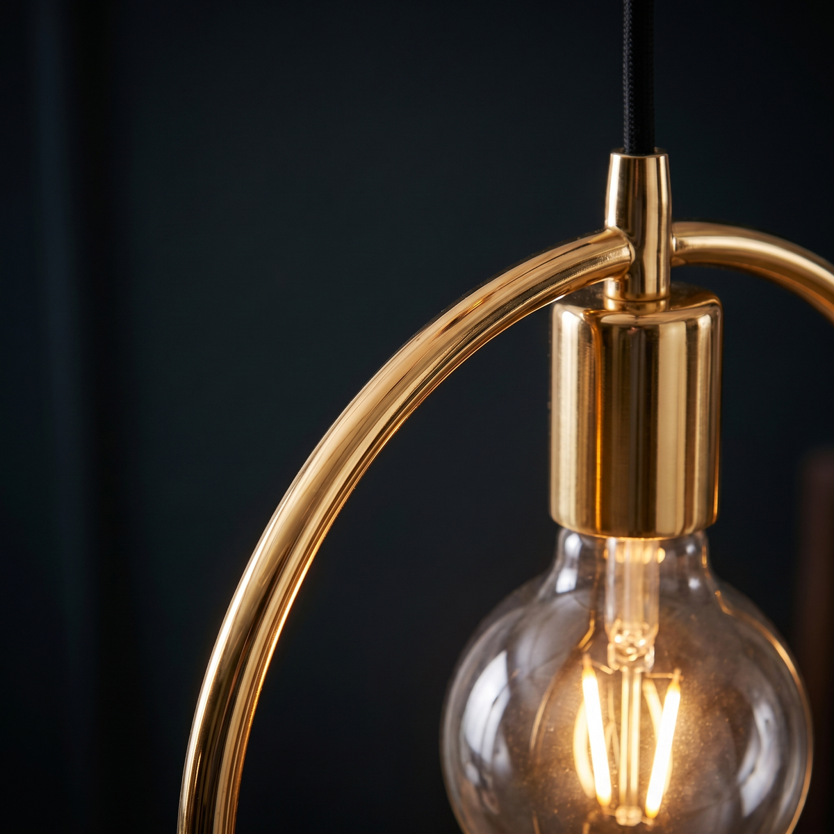 Gold Circle Pendant Light close-up of the gold ring and globe bulb