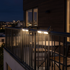 Clip on solar motion lights on a balcony railing at night