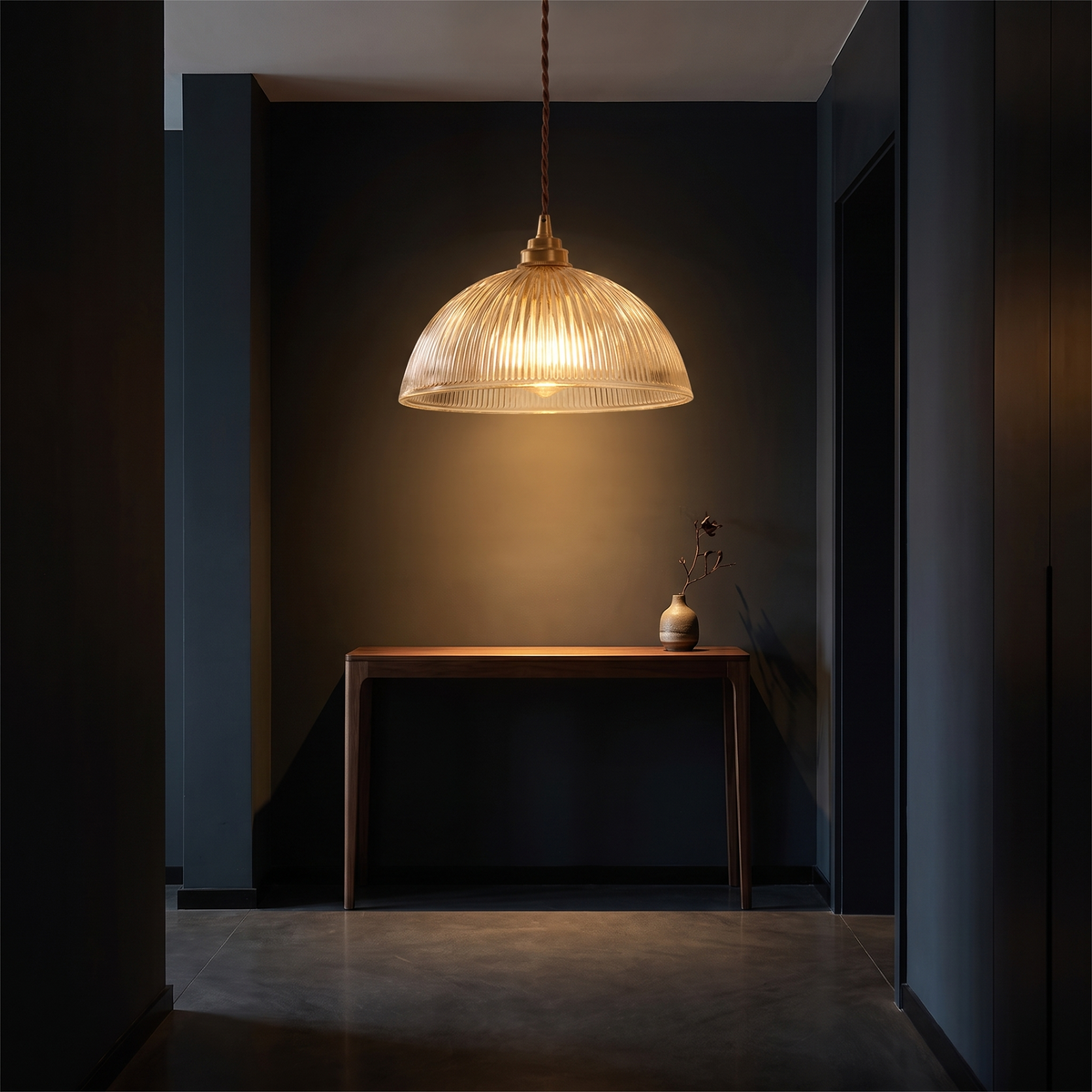 Ribbed glass dome pendant light in a dark entryway